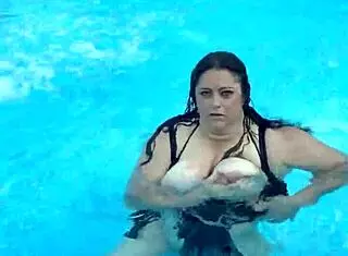 beautiful cute girl with big natural tits splashing in the pool suggestively