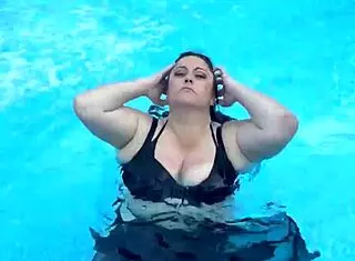 beautiful cute girl with big natural tits splashing in the pool suggestively