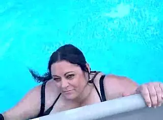 beautiful cute girl with big natural tits splashing in the pool suggestively