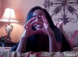 mistress dominates slave with scissorhold