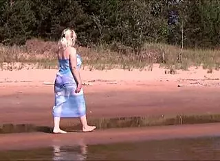 Pretty blonde woman relaxes on the beach with shaved body