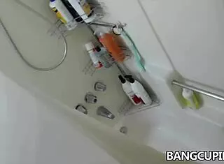 Busty amateur masturbates in shower bath