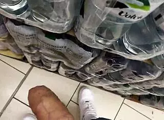 In the supermarket, she helps a guy with a big cock get a risky public cumshot through handjob and spitting