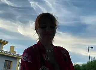 Woman with curves enjoys a swim in the pool while a friend watches