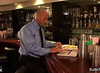 long haired hottie gives suggestive blowjob to bald guy at work.