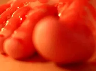 Why is busty Eveline E masturbating with wax?