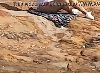 beautiful young girl watched having public sex on beach rocks interrupted by third person