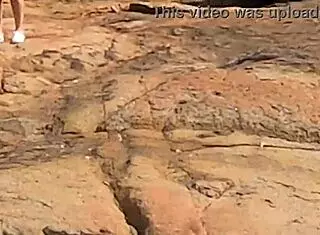 beautiful young girl watched having public sex on beach rocks interrupted by third person