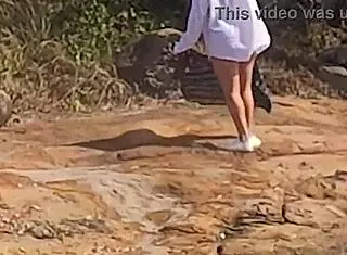 beautiful young girl watched having public sex on beach rocks interrupted by third person