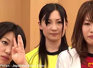 japanese female team listens and takes a lesson from their coach. cute brunette babe in costumes follows instructions closely