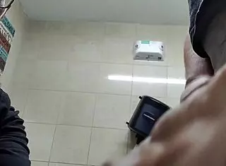 Two guys have a casual meeting in the restroom