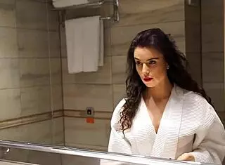 Brunette amateur masturbates shaved pussy in bath, cumming solo