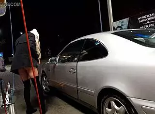 Transsexual washes cars outdoors in public.