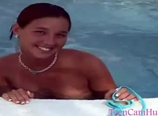 A teen model teases with big tits in bikini by the pool