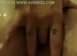 A woman is playing with herself. She fingers her pussy in a detailed masturbation scene.