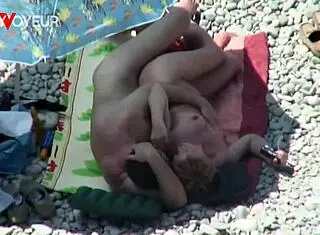 Beach voyeur catches mature couple banging under the sun