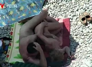 Beach voyeur catches mature couple banging under the sun