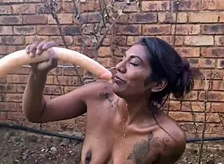 indian slut deepthroats dildo in garden