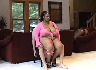 Saphire shows off her big black ass and tits in this german scene