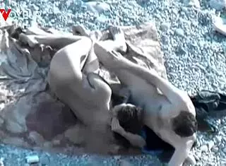 yo, check this hot babe givin’ head on a public beach