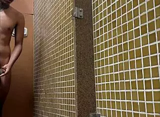 this muscular twink is showering in the gym, and i'm spying on his big cock