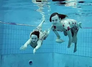 anna and lada relax in pool with bikinis on brunette beauties