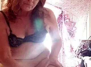 Mature Woman Applies Lotion to Skin