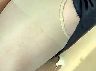 Asian ladyboy displays new thong in stockings at store.