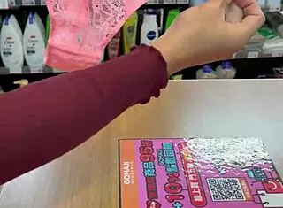 Asian ladyboy displays new thong in stockings at store.