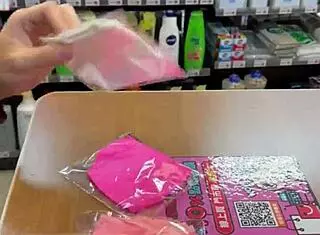 Asian ladyboy displays new thong in stockings at store.