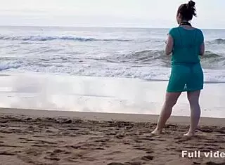 a boy chills reading but she surprises him on the beach