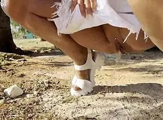 shameless monika fox flashes naked tits while pissing outdoors under a tree.