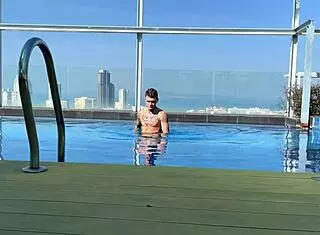 Young Couple Meets and Kisses at Swimming Pool