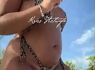 Tanned brunette wife flaunts her huge ass on the beach