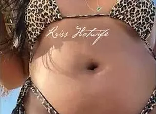 Tanned brunette wife flaunts her huge ass on the beach