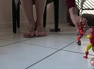 The giantess blonde casually plays with toys and balloons, dominating with her long legs in heels.