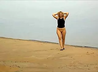 voyeur watches couple dancing on desert island with friends