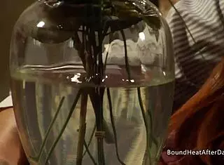 Dom lesbian uses strap on in bondage session.